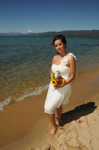 Bride posing by the water