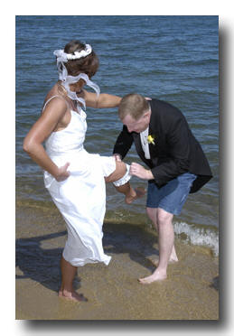 Groom removes garter from bride