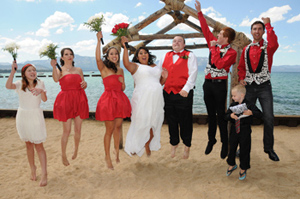 Wedding party jumping for joy