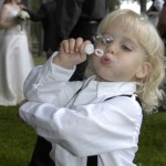 Boy blows bubbles in celebration