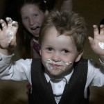 Cake icing on the hands of a boy