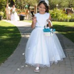 Flower girl throws her petals along the aisle