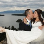 Groom holds his bride in his arms