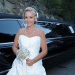 Bride poses beside the limo