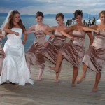 Dancing bridal party girls on the pier