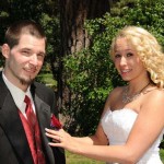 Pinning the boutonniere on her groom