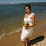 Graceful pose of the bride on the beach