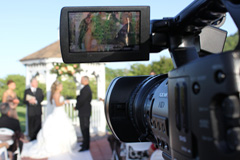 A professional videographer videotaping a wedding