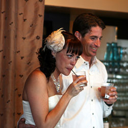 The bride and groom enjoy an alcoholic beverage at thier reception