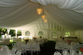 View of the inside of the tent that's setup for a reception
