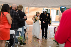 Bride and groom walking down the aisle near the reception area