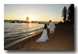 Married couple strolls along the shoreline