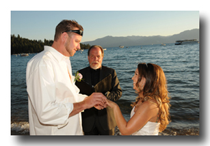 Groom places wedding ring on bride