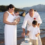 Family conducting a sand ceremony on the beach