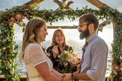 A wedding being conducted at the water's edge at Lakeside Beach